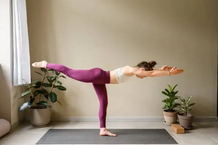 Woman doing Yoga exercise East Grinstead to help with toning the body. 