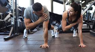 Image of man and woman doing Cardio East Grinstead to tone their arms. 
